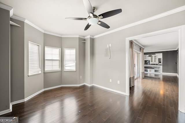 spare room with ceiling fan, dark hardwood / wood-style flooring, and ornamental molding