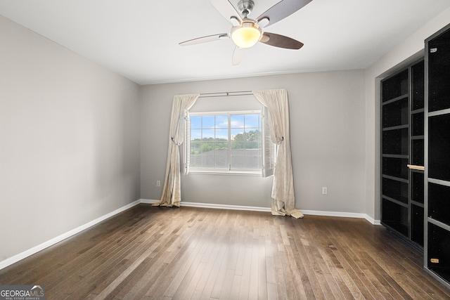 spare room featuring ceiling fan and hardwood / wood-style flooring