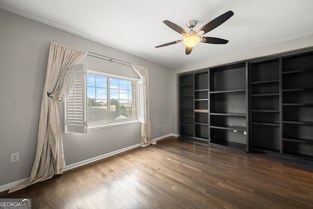 unfurnished room featuring ceiling fan and dark hardwood / wood-style floors