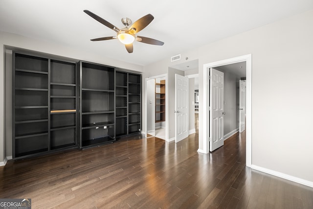 empty room featuring ceiling fan and dark hardwood / wood-style flooring