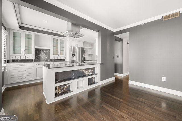 interior space featuring ornamental molding, vanity, tasteful backsplash, and wood-type flooring