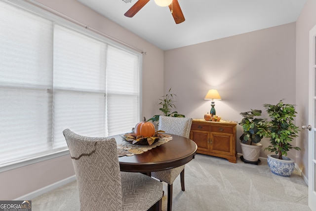 carpeted dining space featuring ceiling fan