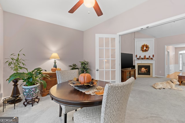 dining room featuring carpet floors, vaulted ceiling, and ceiling fan