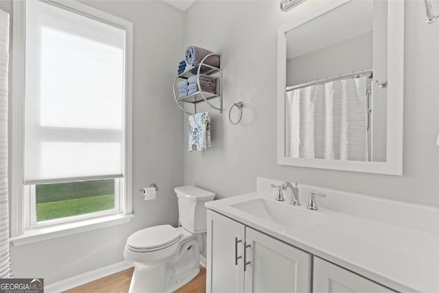 bathroom featuring vanity, toilet, a shower with shower curtain, and hardwood / wood-style flooring