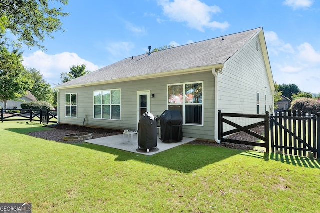 back of house with a yard and a patio