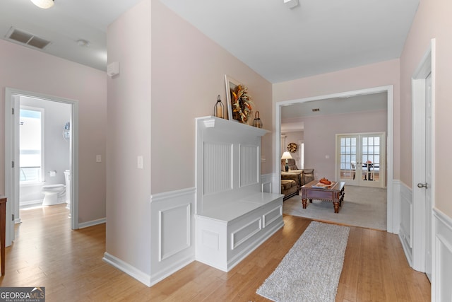 hallway featuring light hardwood / wood-style floors and french doors