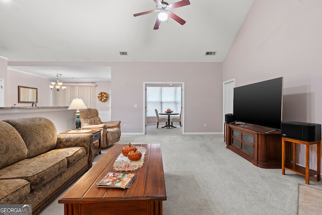 living room with ceiling fan with notable chandelier, lofted ceiling, and light colored carpet