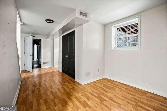 spare room with light hardwood / wood-style flooring