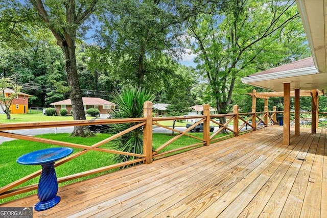 wooden deck featuring a lawn