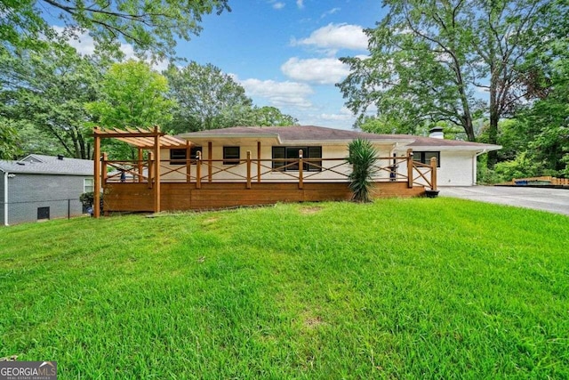 view of front of house with a wooden deck and a front lawn