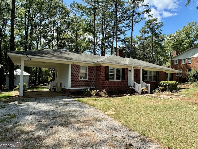 single story home featuring a carport and a front lawn