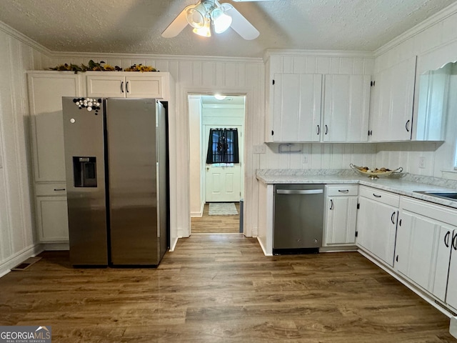 kitchen featuring wood-type flooring, stainless steel appliances, and white cabinetry