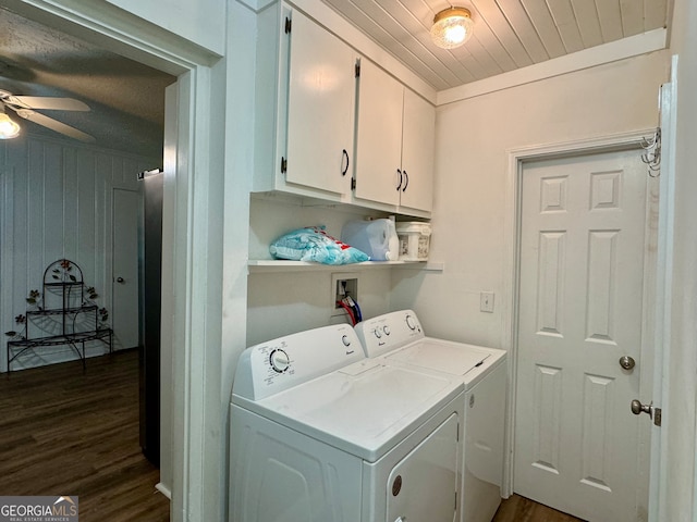 clothes washing area featuring dark wood-type flooring, cabinets, washer and dryer, and ceiling fan