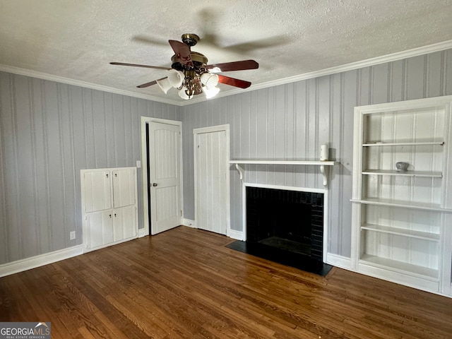 unfurnished living room with dark wood-type flooring, ceiling fan, ornamental molding, and a textured ceiling