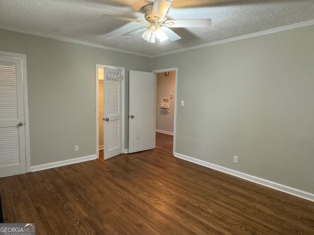 unfurnished bedroom featuring crown molding, dark hardwood / wood-style flooring, ceiling fan, and a textured ceiling