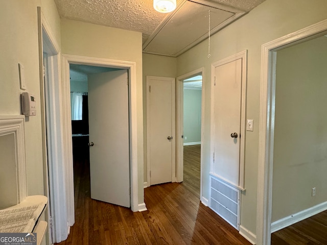 hallway with dark hardwood / wood-style floors