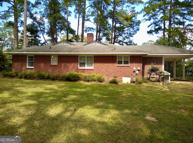 back of property with a lawn