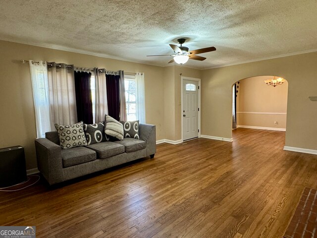 unfurnished living room featuring wood-type flooring, ceiling fan, and a textured ceiling