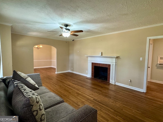 unfurnished living room with ceiling fan, hardwood / wood-style flooring, a fireplace, and a textured ceiling