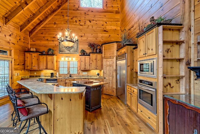 kitchen with beamed ceiling, built in appliances, light hardwood / wood-style floors, and light stone counters