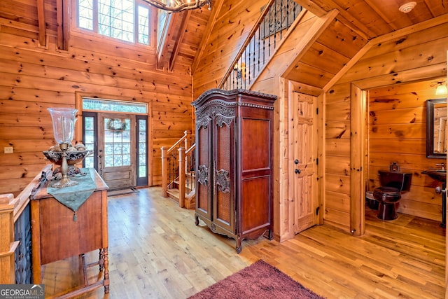 entryway featuring lofted ceiling, wood ceiling, and light wood-type flooring