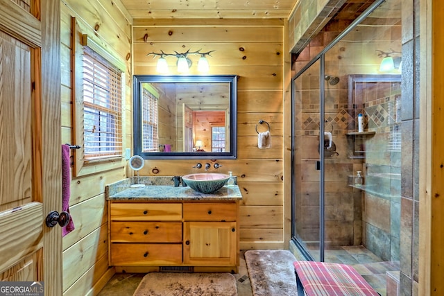 bathroom with walk in shower, vanity, and wooden walls