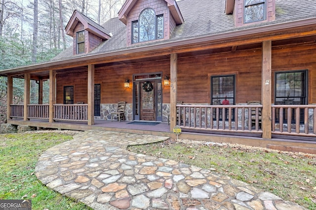 view of exterior entry featuring a porch