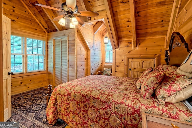 bedroom with multiple windows, vaulted ceiling with beams, wood ceiling, and wood walls