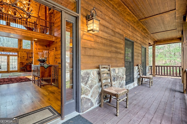 wooden terrace featuring covered porch