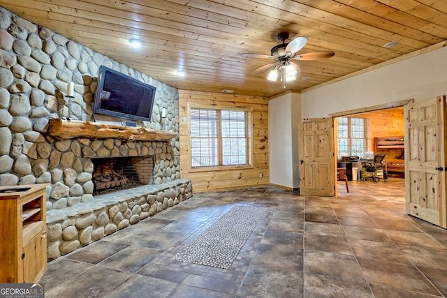 unfurnished living room featuring ceiling fan, wood ceiling, and a fireplace