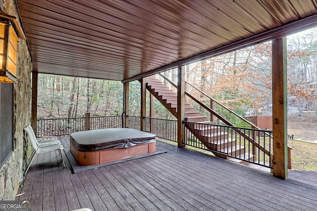 deck with a covered hot tub