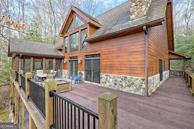 wooden deck with a sunroom