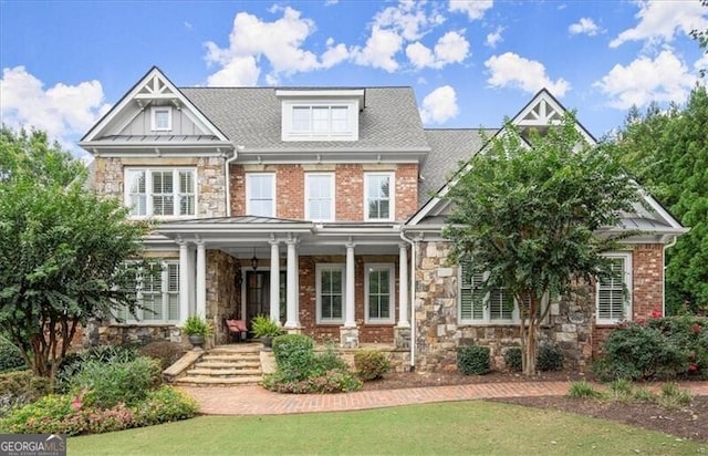 craftsman-style house featuring a porch and a front lawn