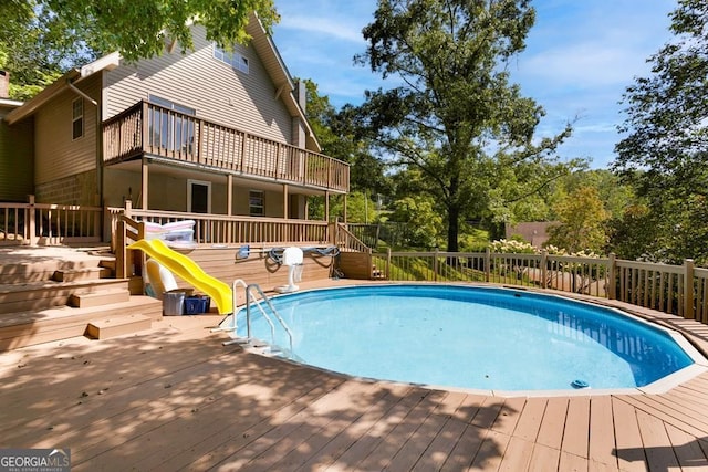 view of swimming pool with a deck