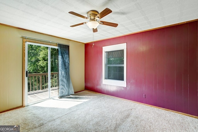 carpeted empty room featuring ceiling fan