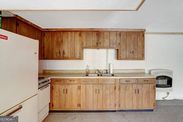 kitchen featuring sink, white appliances, and heating unit