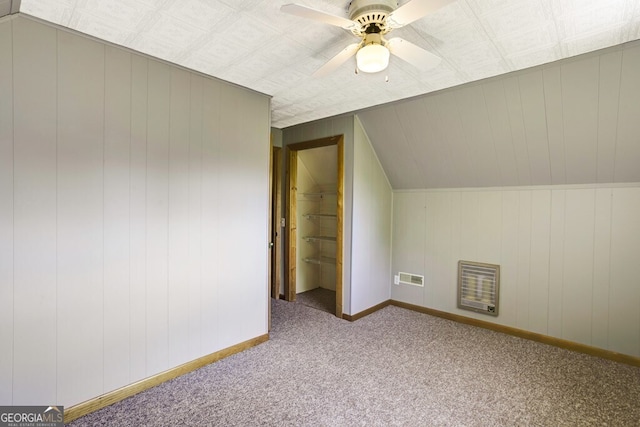 additional living space featuring vaulted ceiling, ceiling fan, and carpet flooring