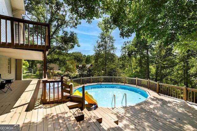 view of swimming pool with a deck