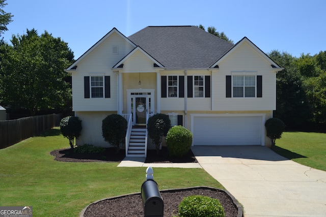 bi-level home with a garage and a front yard