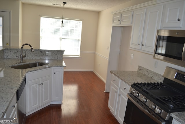 kitchen featuring light stone counters, stainless steel appliances, dark hardwood / wood-style floors, and white cabinets