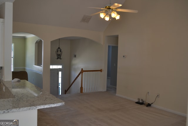 interior space featuring carpet, high vaulted ceiling, and ceiling fan