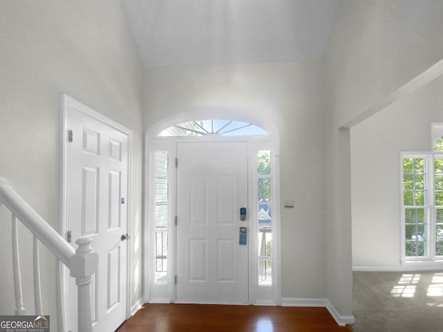 foyer with dark colored carpet