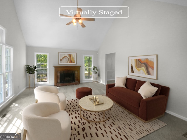 carpeted living room featuring plenty of natural light, ceiling fan, high vaulted ceiling, and a fireplace