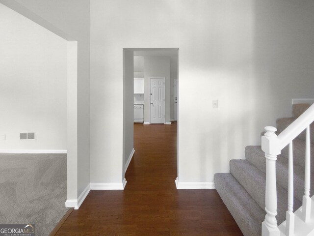 corridor featuring dark wood-type flooring