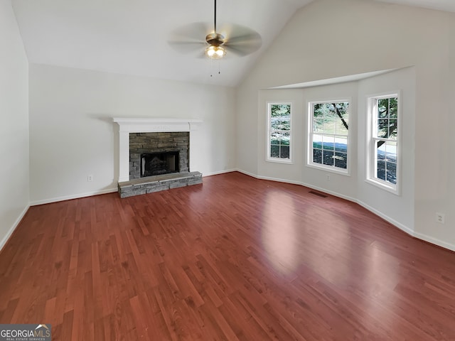 unfurnished living room featuring a fireplace, dark wood-type flooring, vaulted ceiling, and ceiling fan