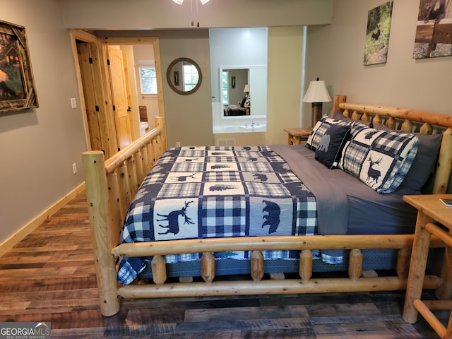 bedroom with dark hardwood / wood-style flooring