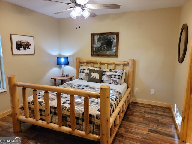 bedroom with dark hardwood / wood-style flooring and ceiling fan