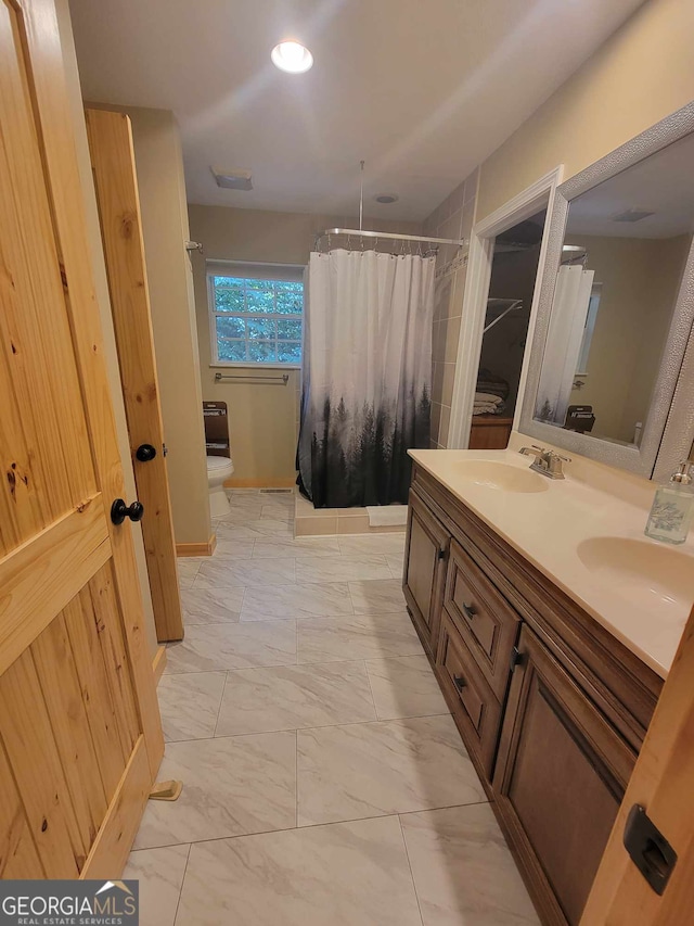 bathroom with vanity, toilet, a shower with curtain, and tile patterned floors