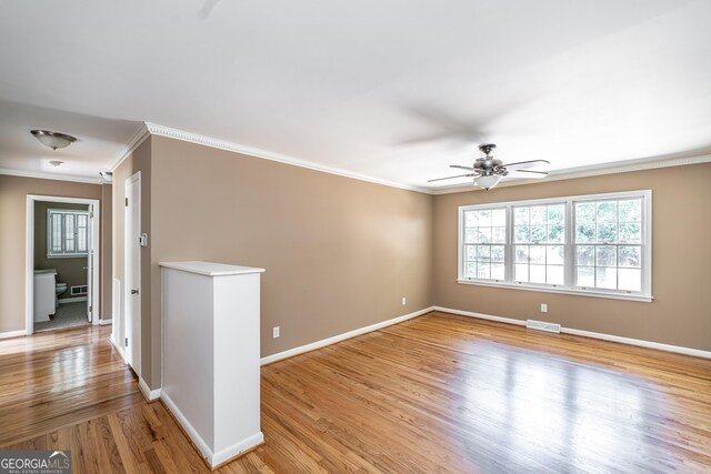 unfurnished room featuring ornamental molding, ceiling fan, and light hardwood / wood-style floors