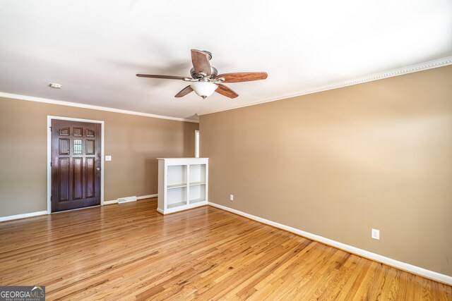 interior space featuring crown molding, ceiling fan, and light wood-type flooring